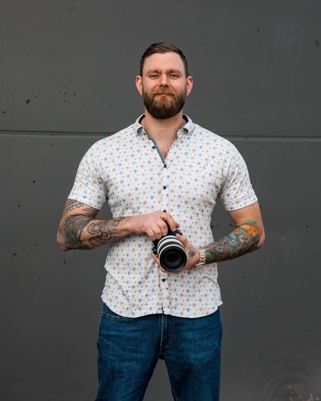 Jonny Fussell, wedding photographer, looking down at his camera