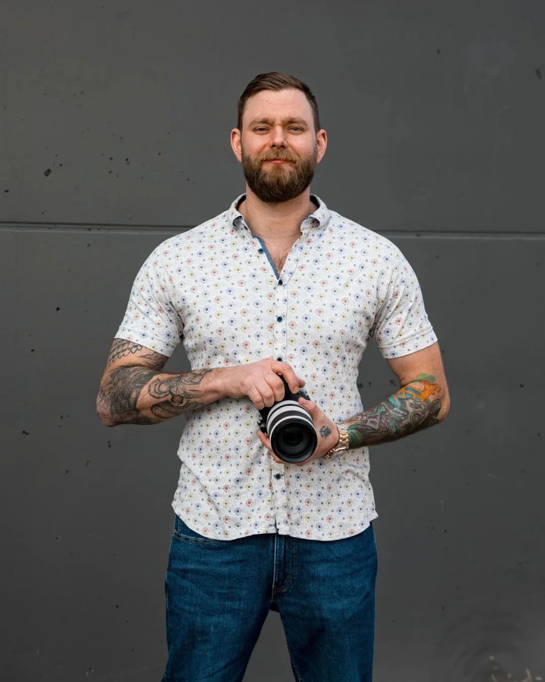 Jonny Fussell, wedding photographer, looking down at his camera